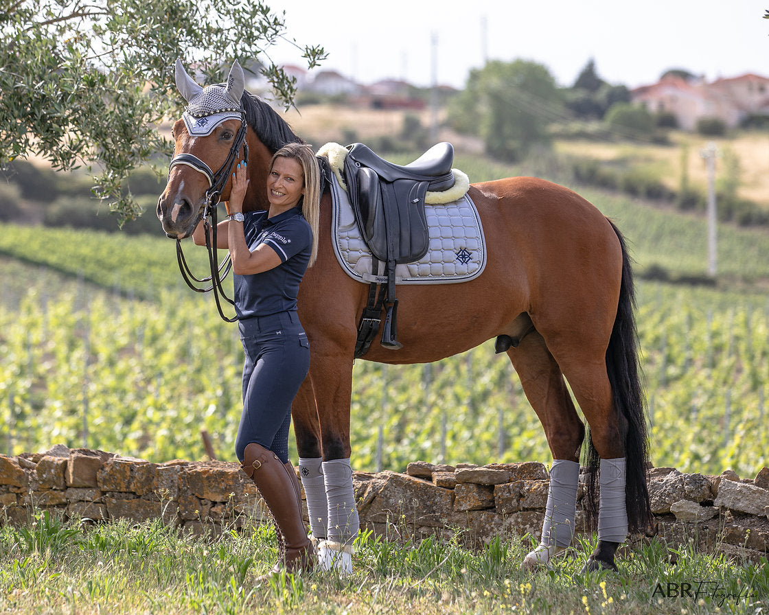 Dapple Dressage horse in Dapple Equestrian Arctic Silver full set Saddle Pad, Fly Veil & Fleece Bandages