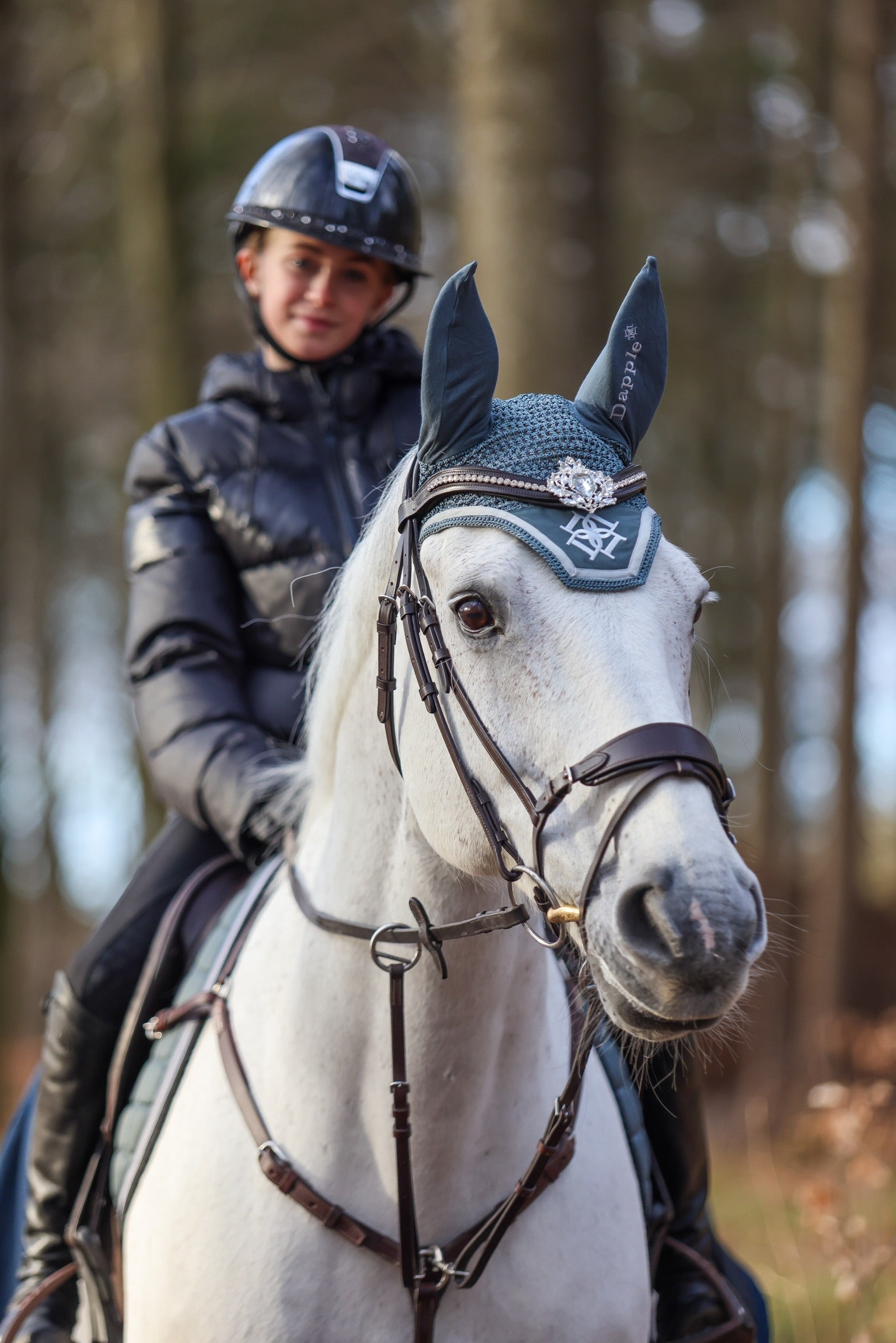 Rider and White Horse wearing Dapple Pine Ear Bonnet