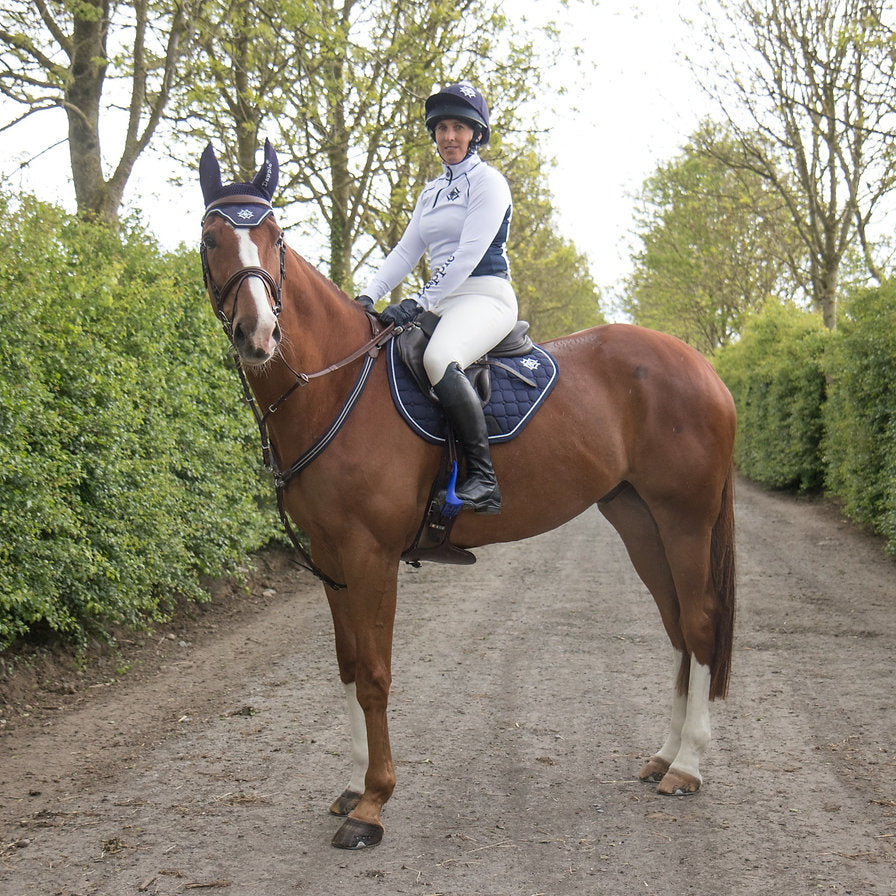 Dapple Rider Sarah Lang - Wearing Dapple Equestrian - Horse wearing Navy Cutaway saddle pad