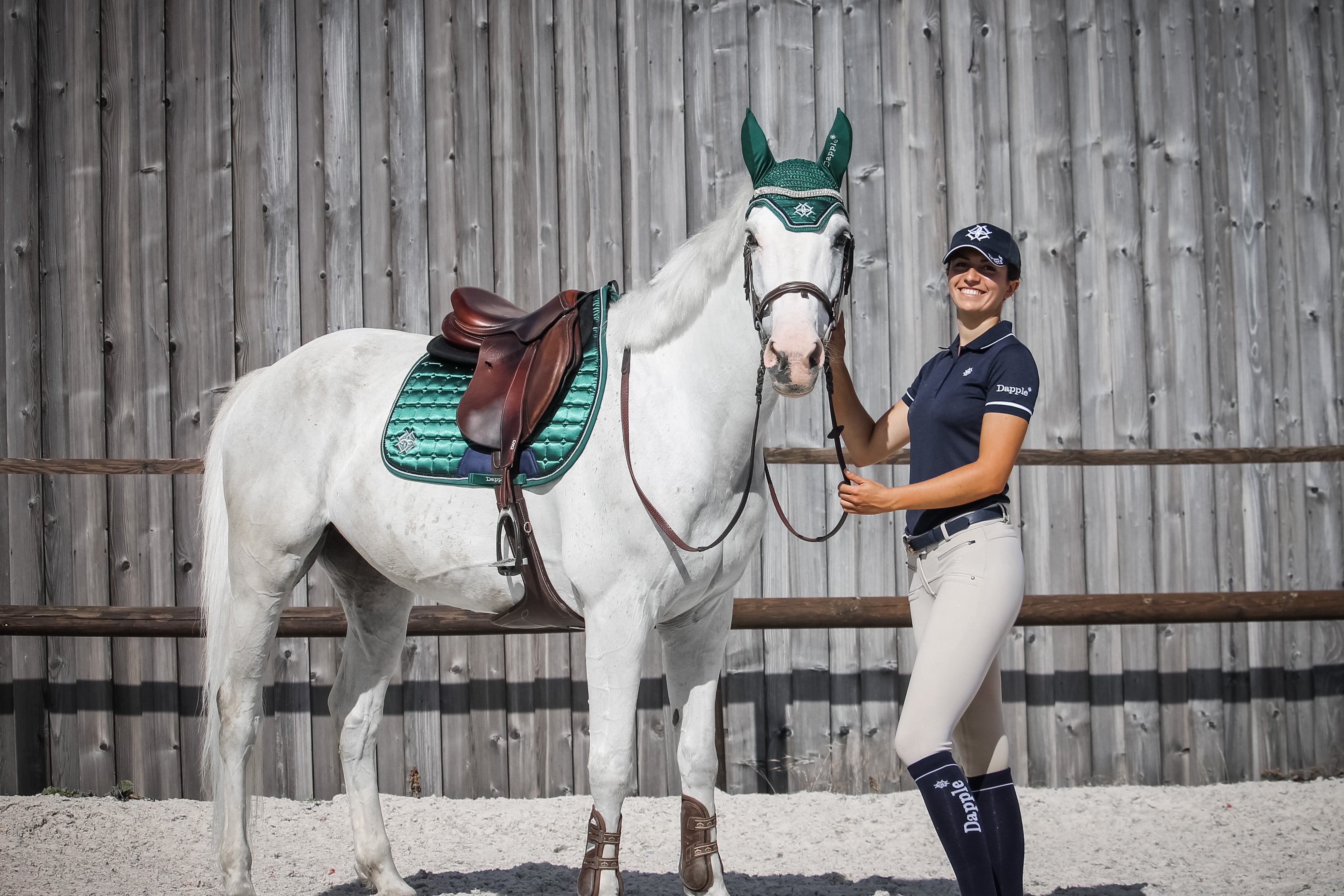 White horse wearing Emerald Green Jump Saddle Pad and Fly Veil
