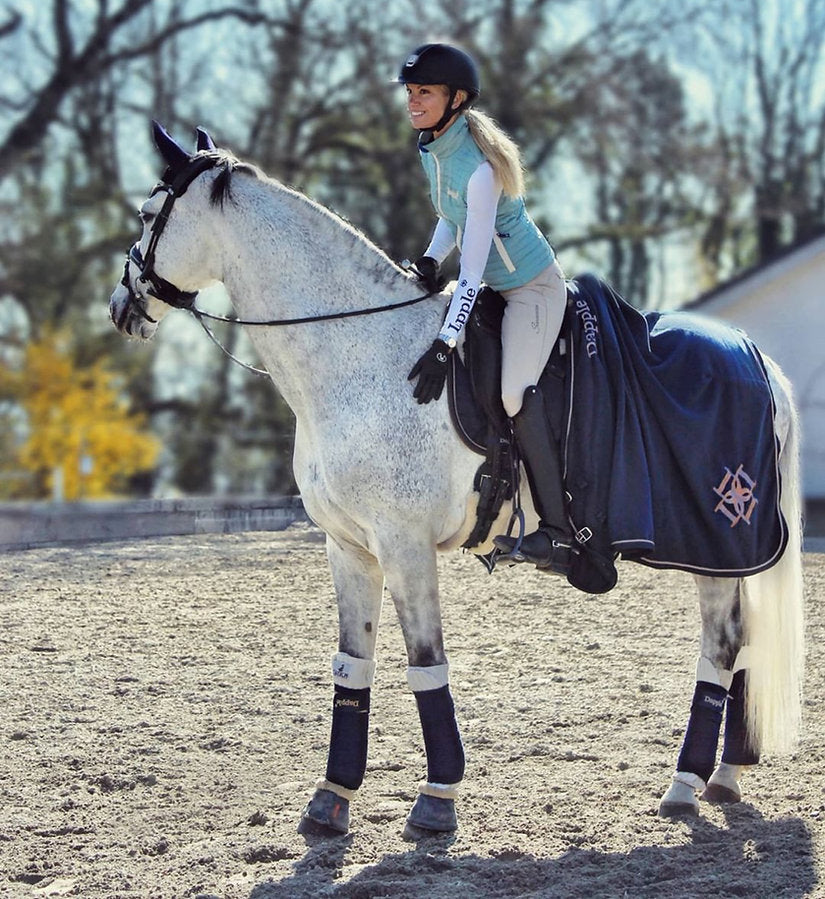 White Horse wearing Dapple Equestrian Horse Rug