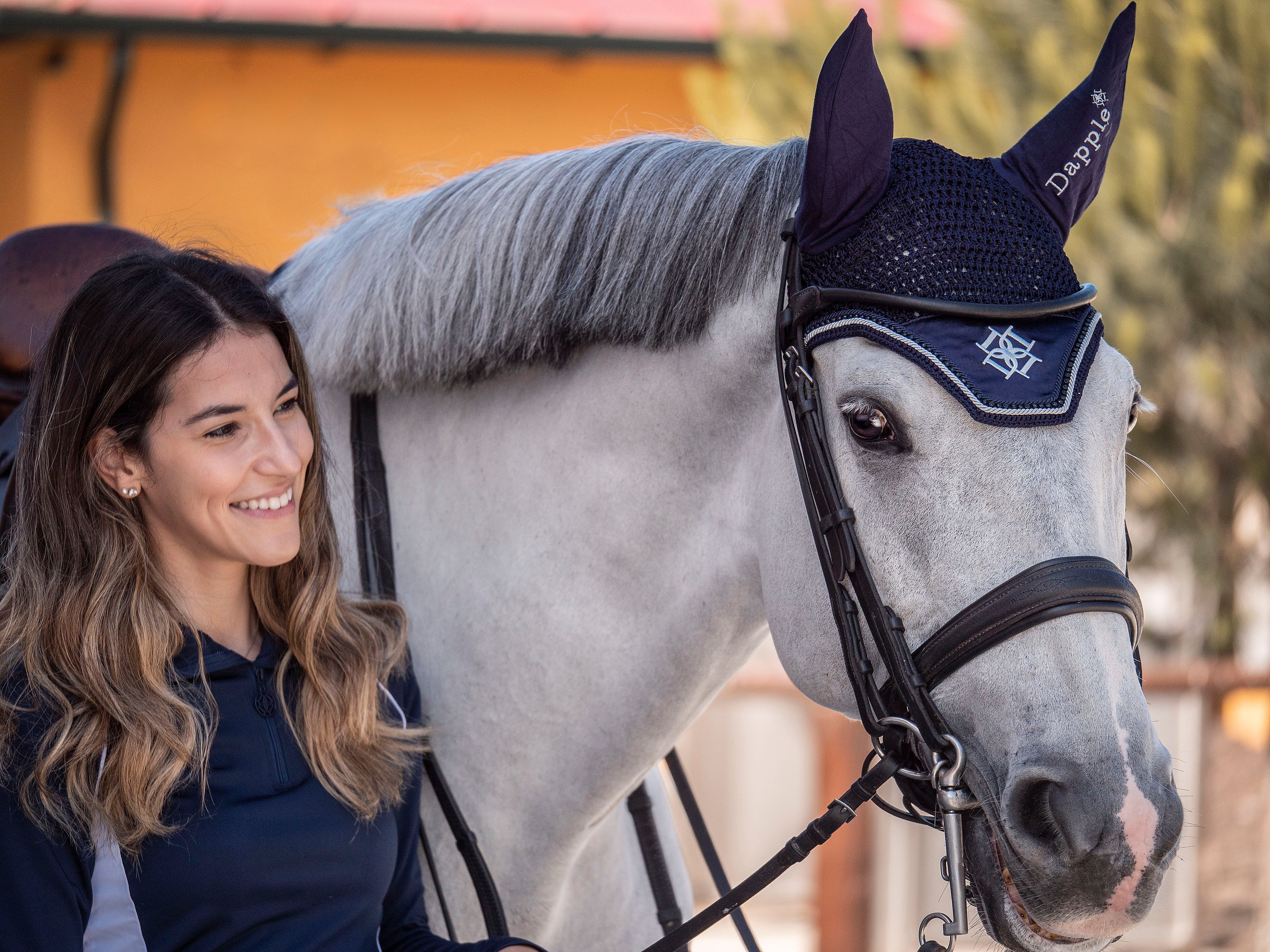 White horse wearing Oxford Blue Ear Bonnet